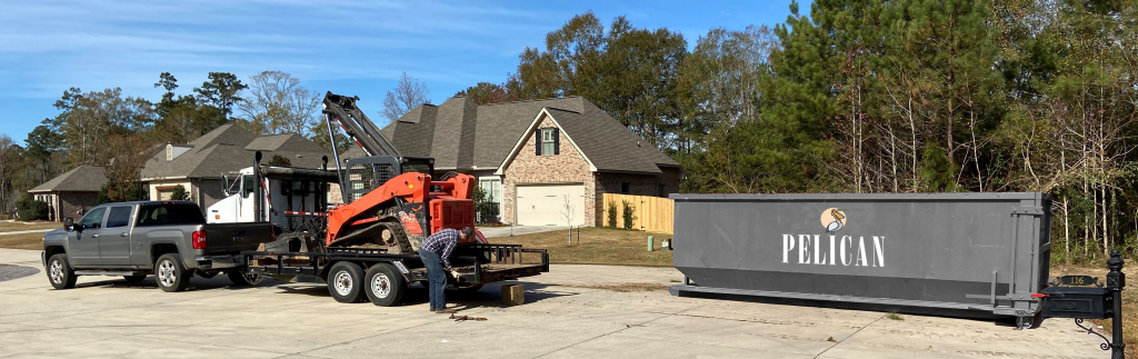 Picture of dumpster with our pelican logo on it.